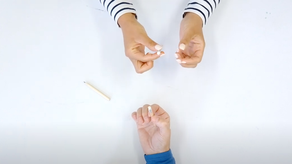 Someone rolling a pencil in their fingers.